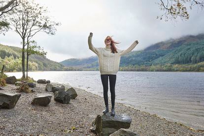 Woman laughing by the side of a loch