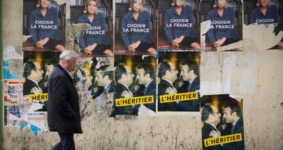 Un home passeja davant dels cartells electorals a París aquest divendres.