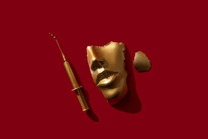 Gold colored syringe and face/ mask on the red background.