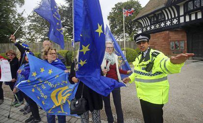 Un policía habla con unos manifestantes contrarios al Brexit, este jueves en Thornton Manor (The Wirral, Inglaterra).