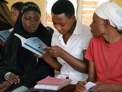 Tres alumnas de la escuela Nyamirambo aprenden a leer en clase.