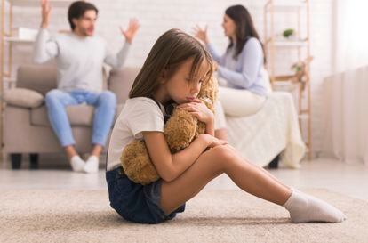 Family Problems. Cute Little Girl Suffering From Parents Arguing, Sitting On Floor With Teddy Bear, Feeling Abandonned And Lonely