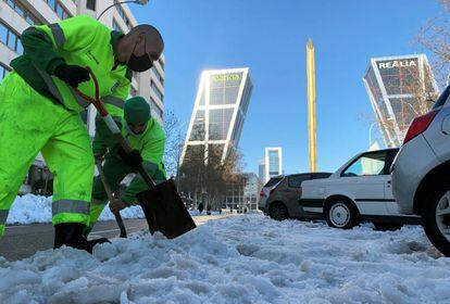Trabajadores quitando la nieve cerca de la sede operativa de Bankia