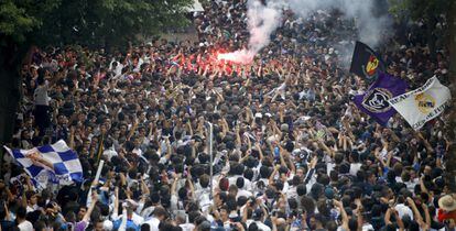 Aficionados del Real Madrid esperan la llegada de los jugadores al estadio Santiago Bernabéu de Madrid.