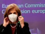 European Commissioner in charge of Health Stella Kyriakides removes a protective facemask as she arrives for a press conference on AstraZeneca Covid-19 vaccine as EU is urging the pharmaceutical company to publish its vaccine contract amid an escalating row over delivery shortfalls, at the European Union headquarters in Brussels on January 27, 2021. (Photo by OLIVIER HOSLET / EPA / AFP)