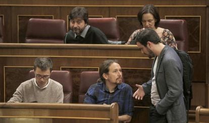 El líder de Podemos, Pablo Iglesias, y el candidato de IU, Alberto Garzón, conversan en el Congreso.