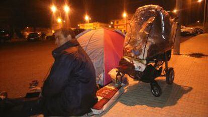 Un hombre acampa en la calle, junto a sus hijos, la noche del martes.