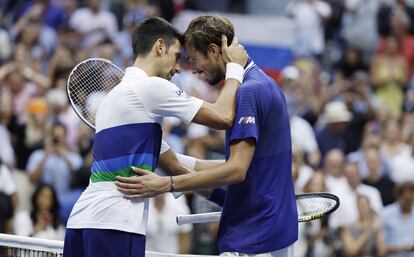 Djokovic and Medvedev hug at the end of the 2021 final.