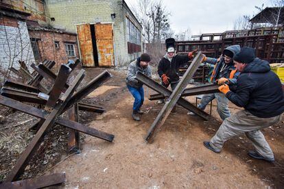 Un grupo de hombres coloca obstáculos antitanque en Leópolis (Ucrania).