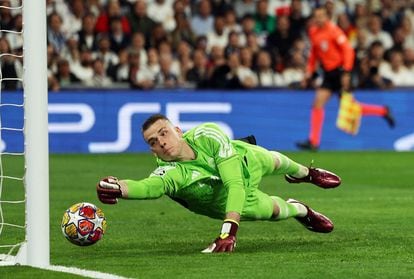 Real Madrid goalkeeper Andriy Lunin dives unsuccessfully at Bernardo Silva's first goal. 