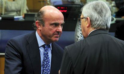 Guindos habla con Juncker en el Eurogrupo del 21 de junio.
