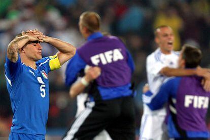 El italiano Cannavaro, en su último partido, se echa las manos a la cabeza mientras los jugadores eslovacos celebran su clasificación para los octavos de final.