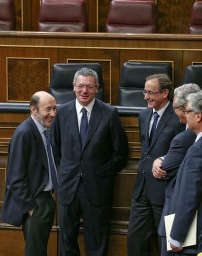 Gallardón conversa en el hemiciclo con Rubalcaba en presencia de otros diputados.