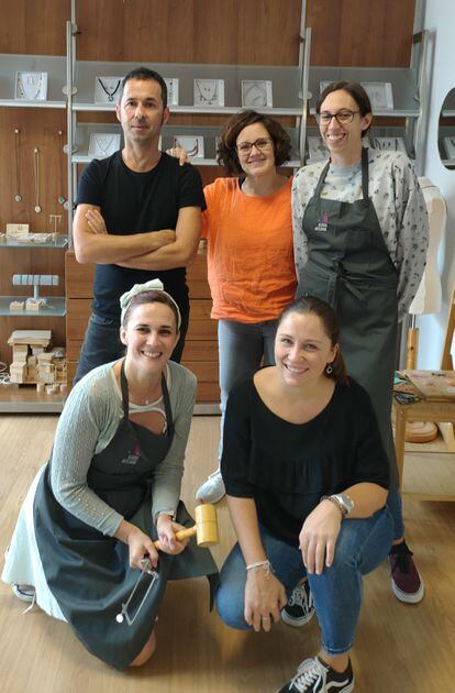 The team from the Albero Artesanos costume jewelery workshop poses together.