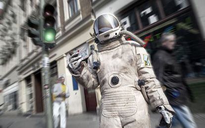Una viandante vestida de astronauta en la calle de Karl Marx, en Berl&iacute;n. 