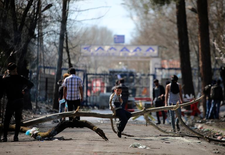 Inmigrantes en el puesto fronterizo de Pazarkule-Kastanies frente a la puerta cerrada a territorio griego, el pasado 11 de marzo.