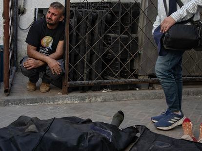 Un trabajador de World Central Kitchen llora junto a los cuerpos de sus colegas después de su traslado al hospital Al-Najjar en Rafah, Gaza.