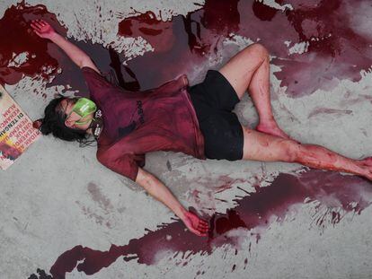 Un activista permanece en el suelo cubierta con sangre ficticia, durante una protesta contra la destrucción del medio ambiente en Yakarta (Indonesia).