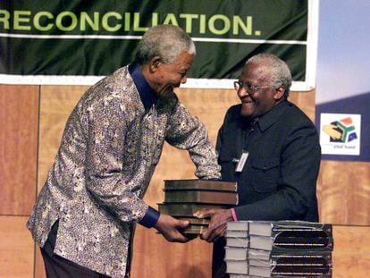 El presidente de la Comisión para la Verdad y la Reconciliación en Sudáfrica, el arzobispo Desmond Tutu (derecha), entrega al presidente del país, Nelson Mandela, el informe de la citada comisión sobre las violaciones de los derechos humanos durante 30 años de 'apartheid', en 1998.