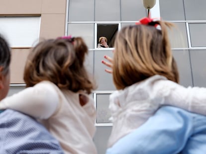 Teresa (i) y Carolina (d) aprovechaban que podían pueden salir a la calle, tras 43 días, para saludar a su abuela, Rosario.