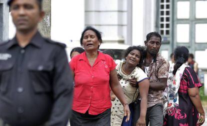 Familiares de las víctimas, cerca de una morgue, este domingo en Colombo.