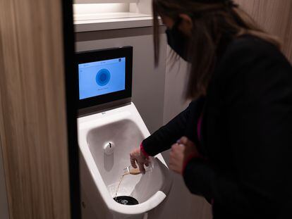 Una azafata realiza una prueba en el urinario inteligente de la Estación de Sants, en Barcelona.