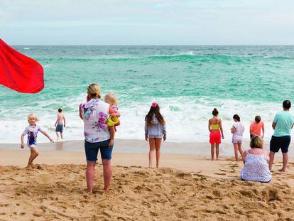 Bandera roja ante el horizonte, en la playa de Porthcurno, Cornwall, Inglaterra, en 2017, un momento post-Brexit.