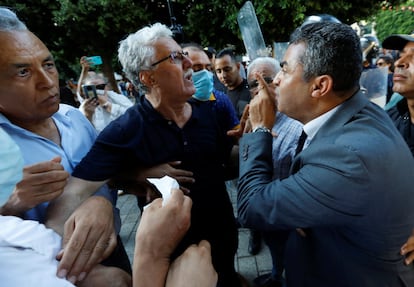 Hamma al-Hammami, a left-wing activist and former political prisoner, grapples with police during a protest by civil society groups against the referendum in Tunis on Tuesday.