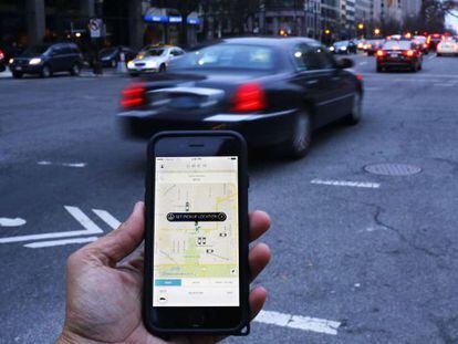 Un hombre muestra la aplicación Uber en su móvil en Washington (EE UU).