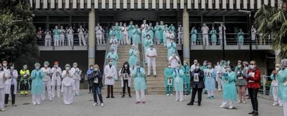 Sanitarios protegidos con mascarillas aplauden conmocionados tras el minuto de silencio en la entrada del Hospital Doctor Peset por la técnica de enfermería fallecida por coronavirus, en Valencia.
 
 