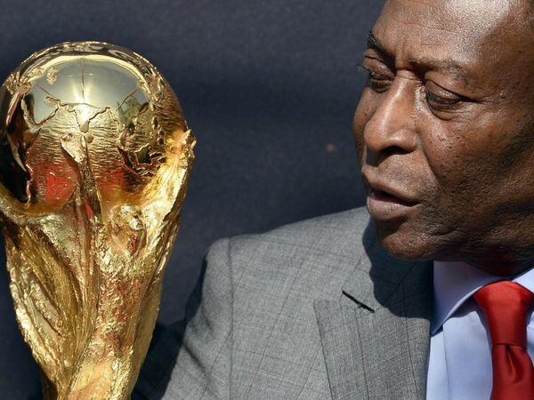 (FILES) In this file photo taken on March 9, 2014 Brazilian football legend Pele looks at the FIFA World Cup trophy during a FIFA event outside the Hotel de Ville in Paris. - Brazilian football legend Pele turns 80 on October 23, 2020. (Photo by FRANCK FIFE / AFP)