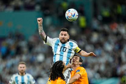 Lionel Messi jumps to finish off a ball in the presence of Nathan Ake. 