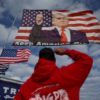 Un partidario de Trump saludaba el lunes a una bandera con su foto cerca del domicilio del magnate en Mar-a-Lago (Florida).