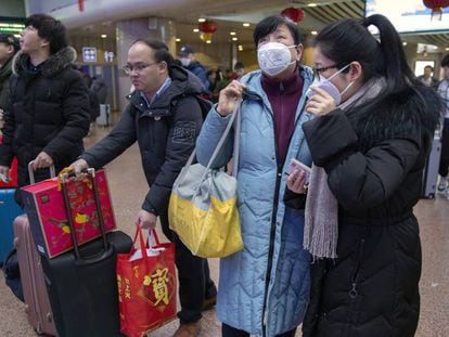 Un grupo de viajeros usa mascarillas en una estación ferroviaria en Pekín, este martes. En vídeo, aumentan a nueve los muertos por coronavirus de China.