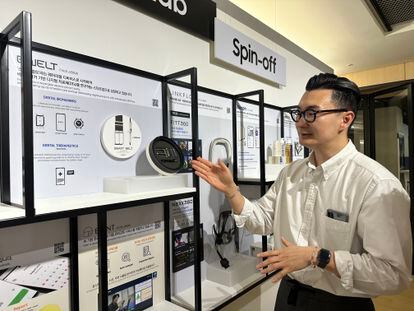 C-Lab employee Jun Kim shows off the smart belt developed by Belt