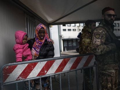 Una mujer y su hijo son desalojados por el ejército del centro de inmigrantes de Castelnuovo.