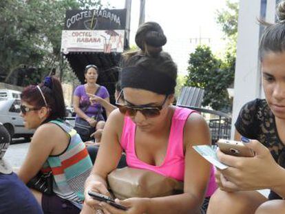 Varias personas se conectan a Internet en la avenida 23 de la Habana. 
