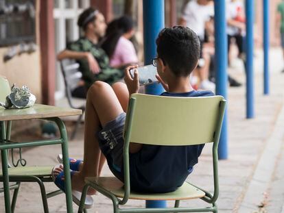 Un infant amb un mòbil a l'IES La Ribera aMontcada i Reixac.