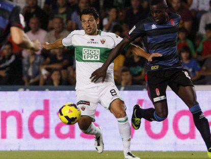 Nyom pelea un balón con Mantecón, del Elche.