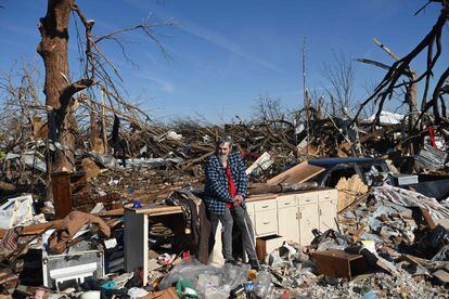Bogdan Gaicki, a resident of the affected area, observes the damage caused by tornadoes that killed at least 90 people this weekend in the United States.