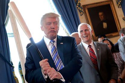 Mike Pence ríe mientras Donald Trump blande un bate de béisbol, en julio de 2017 en la Casa Blanca.