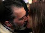 Banderas kisses his girlfriend Kimpel inside a church as he takes part as a penitent in the &quot;Lagrimas and Favores&quot; brotherhood in a Palm Sunday procession at the start of Holy Week in Malaga