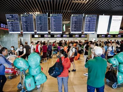 Pasajeros esperando ante los mostradores de facturación en el aeropuerto de Barajas.
