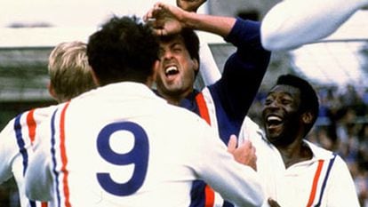Sylvester Stallone, abrazado por sus compañeros (Pelé, a la derecha), tras parar el penalti en 'Evasión o victoria'.