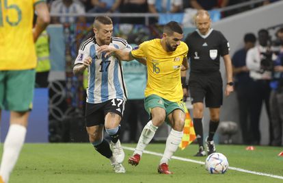 Alejandro Gómez disputes a ball with Aziz Behich.