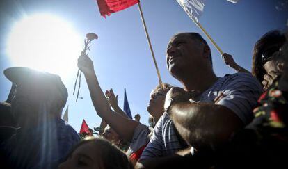 Una mujer levanta un clavel en la protesta de hoy en Lisboa.
