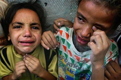 Las hermanas de Ghadir Mujimar, una niña palestina herida ayer mientras estaba en clase, lloran su muerte.