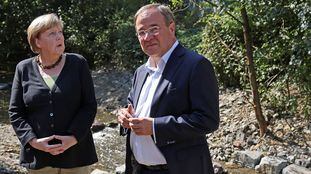 German Chancellor Angela Merkel and North Rhine-Westphalia's State Premier, Christian Democratic Union (CDU) party leader and candidate for chancellor Armin Laschet, visit a region affected by recent floods in Hagen, Germany, September 5, 2021. Oliver Berg/Pool via REUTERS