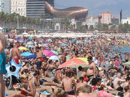 Ba&ntilde;istas en la playa de la Barceloneta (Barcelona) el domingo 13 de agosto. 