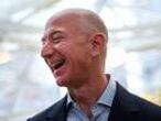 FILE PHOTO: FILE PHOTO: Amazon founder and CEO Jeff Bezos laughs as he talks to the media while touring the new Amazon Spheres during the grand opening at Amazon's Seattle headquarters in Seattle, Washington, U.S., January 29, 2018. REUTERS/Lindsey Wasson/File Photo/File Photo